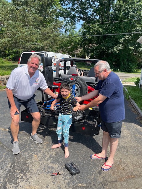 Patrick in front of Jeep with Bike