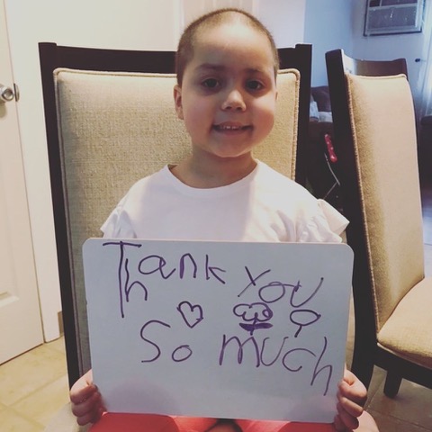 Sophie holding Thank You sign.